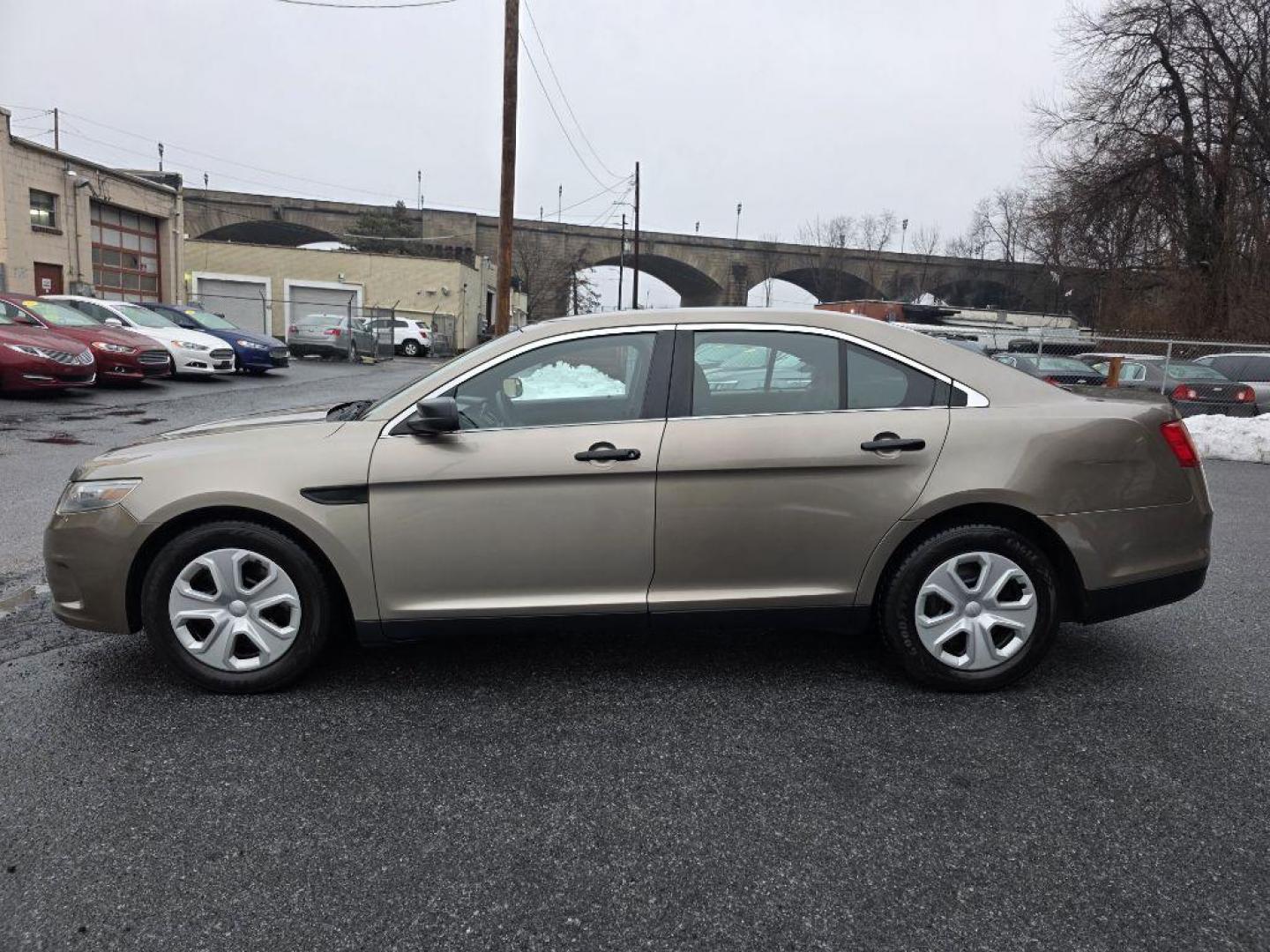 2013 GOLD FORD TAURUS POLICE INTERCEPTOR (1FAHP2M87DG) with an 3.5L engine, Automatic transmission, located at 117 North Cameron Street, Harrisburg, PA, 17101, (717) 963-8962, 40.266762, -76.875259 - WE FINANCE!!! Good Credit/ Challenged Credit/ No Credit - ALL Trade-Ins Welcomed!!! APPLY ONLINE or CALL us TODAY ;) Please call us to discuss your cash and/or financing options. - Photo#1